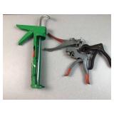 green caulking gun, likely a drip-free model,