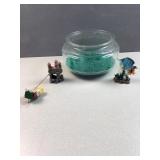 Circular fish bowl with teal rocks, castle and