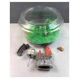 Circular fish bowl with green rocks, plants and