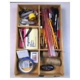 Office supplies & other items in wood desk tray