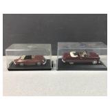 (2) die cast metal cars in display