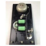 Vintage electric bell mounted on board for ease of