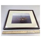 Framed photo of an off shore oil rig operation