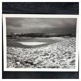 Snow-Dusted Golf Green with Clubhouse in Distance