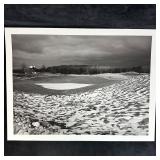Snow-Dusted Golf Green with Clubhouse in Distance