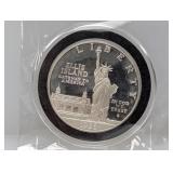 1986-S 90% Silv Ellis Isl Comm $1 Dollar