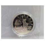 1986 90% Silv Ellis Isl Comm $1 Dollar