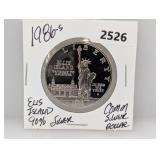 1986-S 90% Silv Ellis Isl Comm $1 Dollar