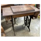 Antique Singer treadle sewing machine in a wooden