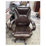Brown leather rolling office chair. Normal wear