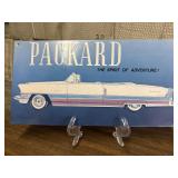 Decorative metal sign featuring a vintage Packard