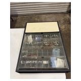 Storage cabinet for car light bulbs full of bulbs