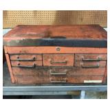 Red metal toolbox with seven drawers.