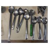 GROUP OF STAINLESS SLOTTED SERVING SPOONS