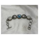Button style toggle bracelet. Crosses, clear and