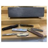 Bundle of pocket knives and sharpening block.