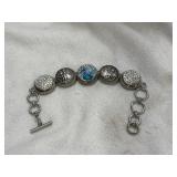 Button style toggle bracelet. Crosses, clear and