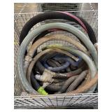 Various used industrial hoses, including a thick