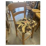 1 wooden bar stool with a cushioned seat