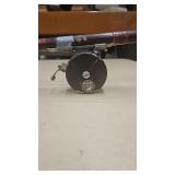 Vintage Fjord fly fishing reel attached to a rod