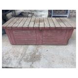 Weathered red wooden outdoor storage deck box
