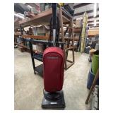 Red Oreck Axis bagged upright vacuum cleaner.