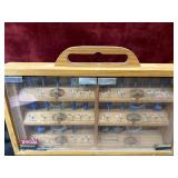 Ryobi router bit set housed in a wooden cabinet