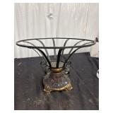 A decorative footed bowl featuring a wrought iron