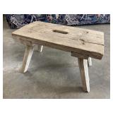 Rustic wooden stool featuring a weathered natural