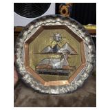 A vintage, handcrafted decorative plate from