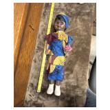 African-themed doll featuring a vibrant yellow,