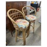 Two mid-century style swivel barstools featuring
