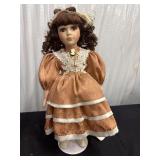 CollectIble porcelain Doll Brunette Orange Dress