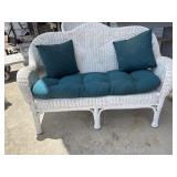 White wicker Love seat with cushions.