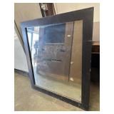 Large black framed mirror.