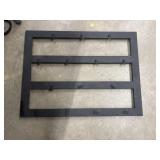 A wooden rack with clips to hang things on for