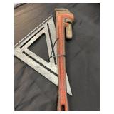 Swanson Speed Square and pipe wrench.