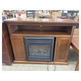 Real Flame electric fireplace features a wood