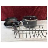 Skillets, cooking pot, and  metal sink organizer.