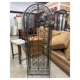 Vintage wrought iron wine rack features a