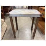 Industrial-style table features a galvanized iron