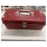 Vintage red metal toolbox with a hip roof design