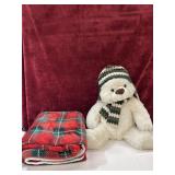Buffalo plaid throw and plush teddy bear.