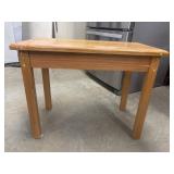 Small kids wooden table features a light oak