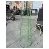 4 green, wire-frame tomato cages.
