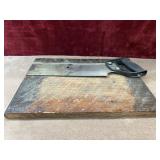 Stanley hand saw and wooden board.