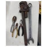 A rusty vintage-style iron pipe wrench and a