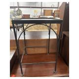 Black metal side table features a sleek,
