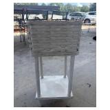 White-painted wicker and wood plant stand.
