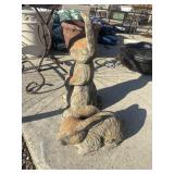 2 weathered, upright garden rabbit statues.
